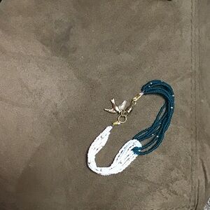 Elegant Beaded Bracelet with Bird Charm